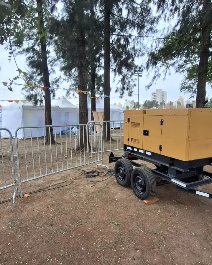 Grupo electrógeno trifásico junto al vallado de un evento